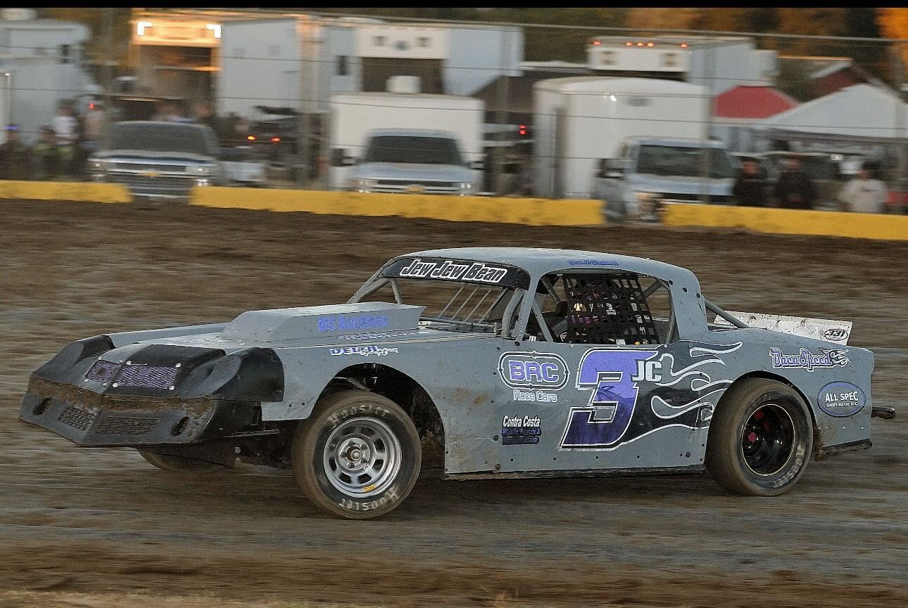Gray and blue #3JC Camaro at speed